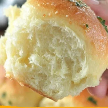 Freshly baked 30-minute dinner rolls on a wooden table