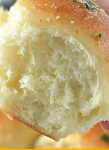 Freshly baked 30-minute dinner rolls on a wooden table