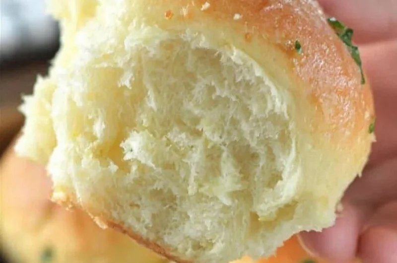Freshly baked 30-minute dinner rolls on a wooden table