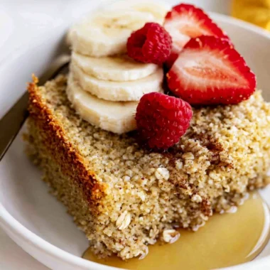 Delicious baked oatmeal topped with fruits and nuts in a baking dish