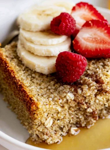 Delicious baked oatmeal topped with fruits and nuts in a baking dish