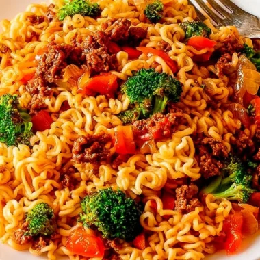 Delicious beef ramen noodles stir fry served in a bowl with green onions