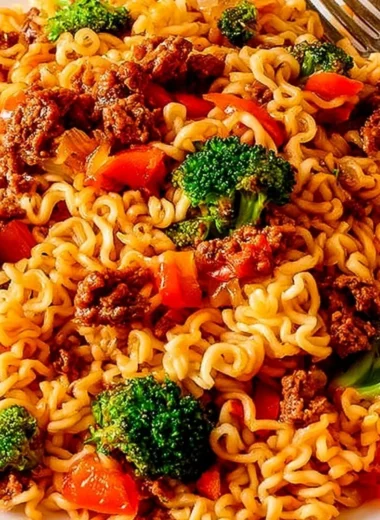 Delicious beef ramen noodles stir fry served in a bowl with green onions