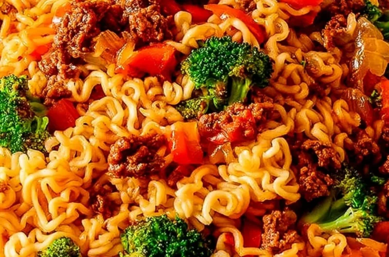 Delicious beef ramen noodles stir fry served in a bowl with green onions