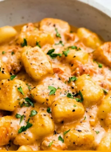 A bowl of garlic butter gnocchi with herbs and melted butter