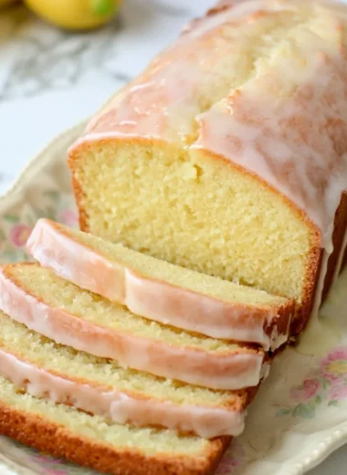 Gluten-free lemon loaf with sweet glaze on a wooden table