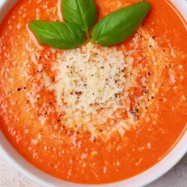 High protein tomato soup served in a bowl with fresh ingredients