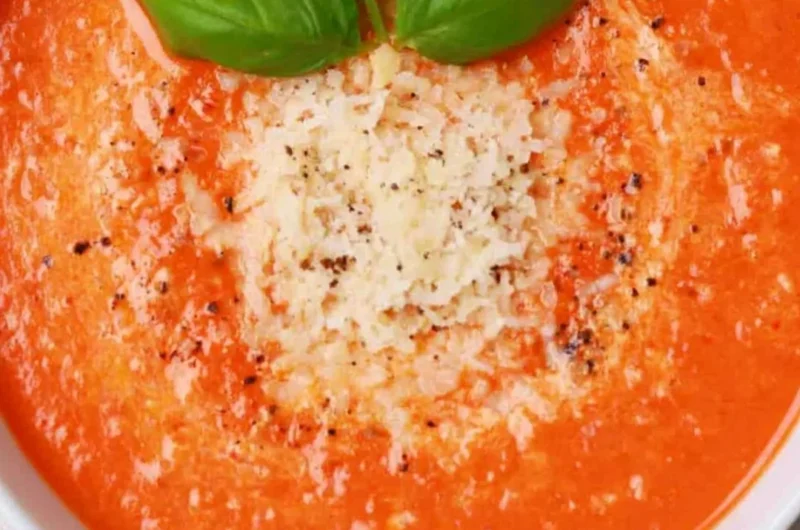High protein tomato soup served in a bowl with fresh ingredients
