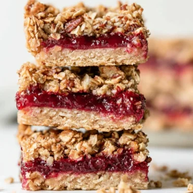 Delicious leftover cranberry sauce oat bars on a wooden table