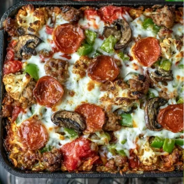 Low carb pizza casserole topped with cheese and pepperoni in a baking dish