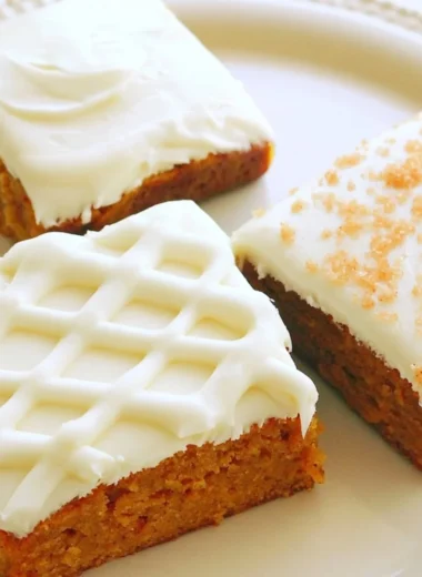 Delicious pumpkin bars topped with creamy frosting, perfect for fall desserts.