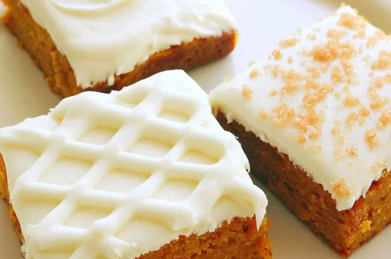 Delicious pumpkin bars topped with creamy frosting, perfect for fall desserts.