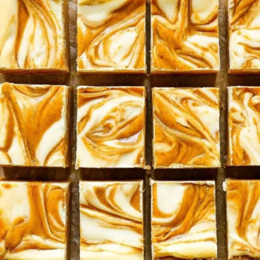 Delicious Pumpkin Cream Cheese Cheesecake Bars on a decorative plate