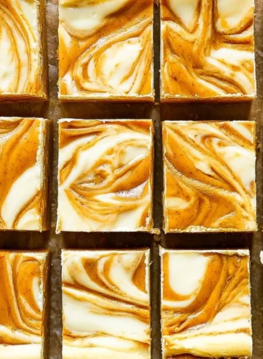 Delicious Pumpkin Cream Cheese Cheesecake Bars on a decorative plate