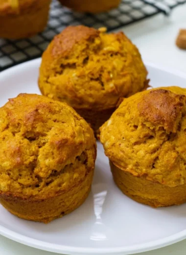 Delicious homemade pumpkin oatmeal muffins on a wooden table
