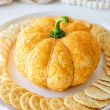 Pumpkin shaped cheese ball decorated for fall celebrations