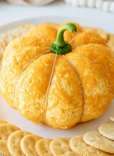 Pumpkin shaped cheese ball decorated for fall celebrations