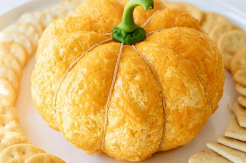 Pumpkin shaped cheese ball decorated for fall celebrations