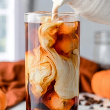 Delicious pumpkin spice cold brew served in a cozy autumn setting.