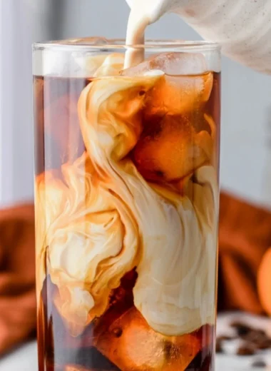 Delicious pumpkin spice cold brew served in a cozy autumn setting.