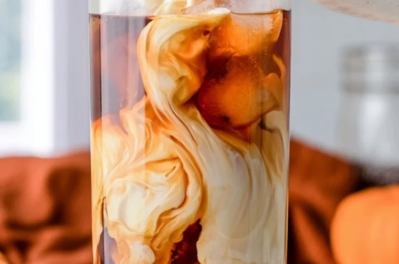 Delicious pumpkin spice cold brew served in a cozy autumn setting.