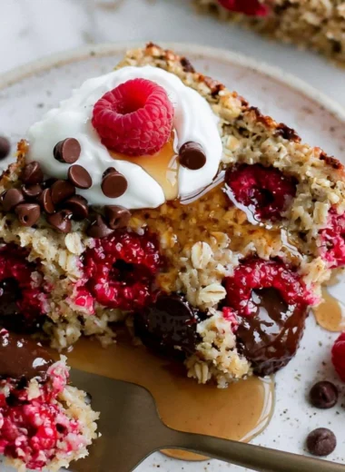 Delicious raspberry chocolate chip baked oatmeal served in a bowl.