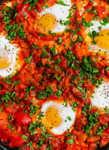 Colorful Shakshuka with poached eggs and vibrant tomato sauce in a skillet