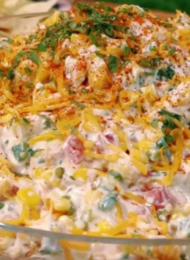 Delicious cold street corn dip served in a bowl with toppings for parties