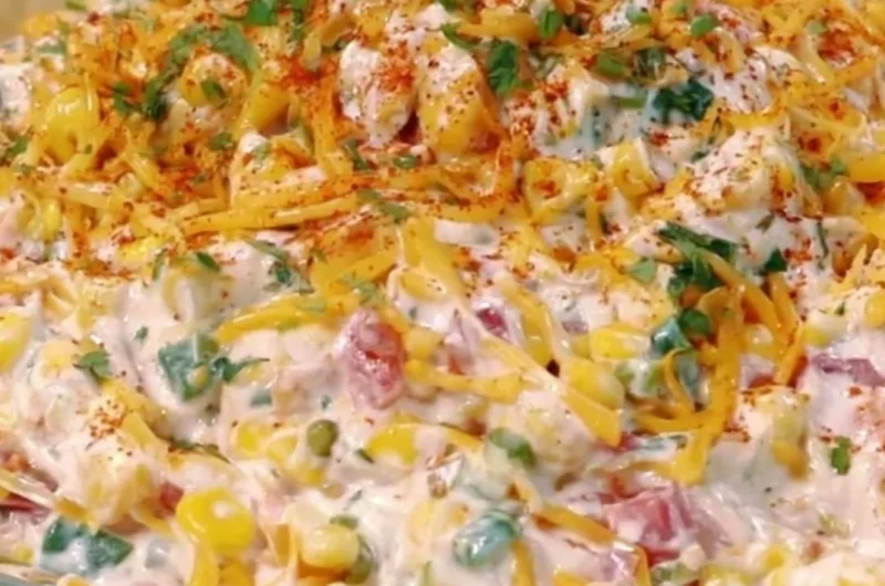 Delicious cold street corn dip served in a bowl with toppings for parties