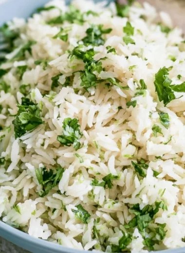 Bowl of cilantro lime rice, a Chipotle copycat recipe, garnished with fresh cilantro
