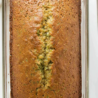 Delicious homemade zucchini bread sliced on a wooden cutting board