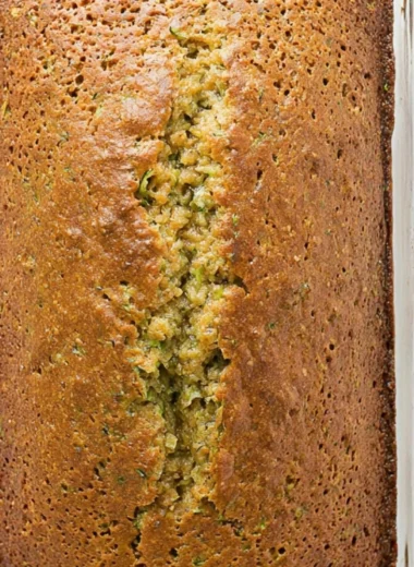 Delicious homemade zucchini bread sliced on a wooden cutting board