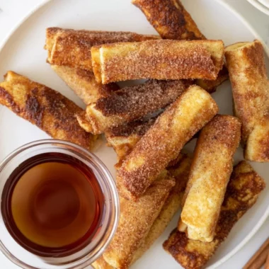 Delicious French Toast Roll-Ups served on a plate with syrup