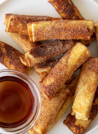 Delicious French Toast Roll-Ups served on a plate with syrup