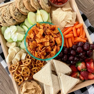 Colorful after school snack board with various fruits, vegetables, and treats.