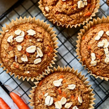 Freshly baked Carrot Apple Muffins on a wooden table