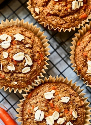 Freshly baked Carrot Apple Muffins on a wooden table