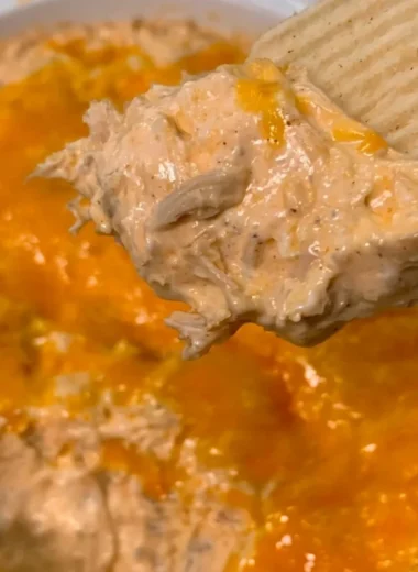 Creamy Chicken Taco Dip served in a bowl with tortilla chips on the side.