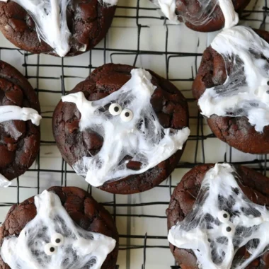 Halloween double chocolate spider web cookies on a spooky-themed plate