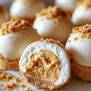No bake pumpkin cheesecake balls topped with whipped cream and spices.