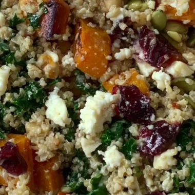 Delicious warm harvest quinoa bowl with seasonal vegetables and herbs