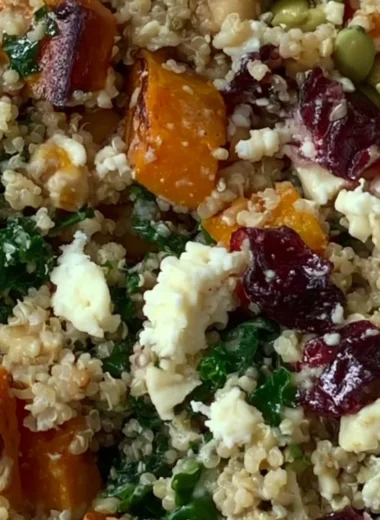 Delicious warm harvest quinoa bowl with seasonal vegetables and herbs