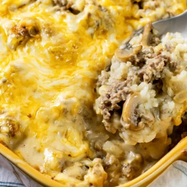 Cheesy Ground Beef and Rice Casserole in a baking dish topped with melted cheese
