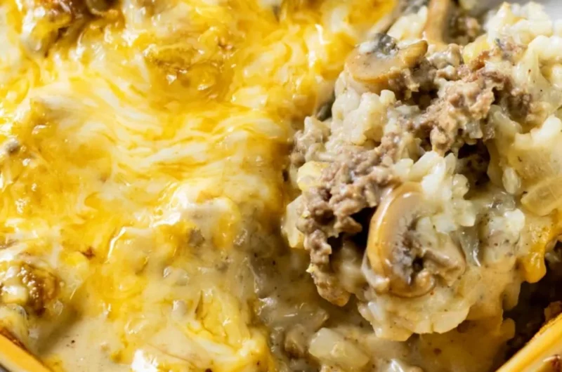 Cheesy Ground Beef and Rice Casserole in a baking dish topped with melted cheese
