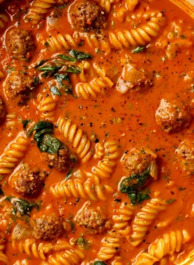 Bowl of creamy Italian meatball soup with fresh herbs and ingredients