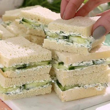 Delicious cucumber sandwiches served on a platter for afternoon tea.