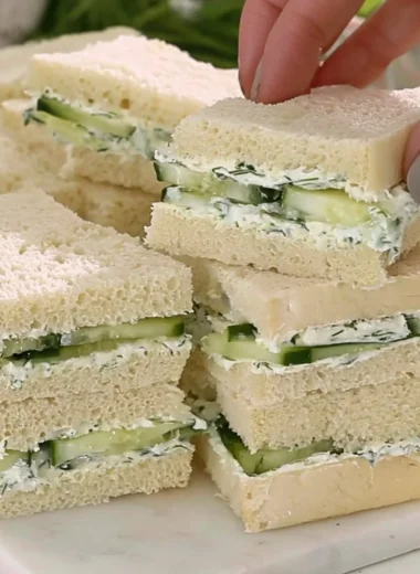 Delicious cucumber sandwiches served on a platter for afternoon tea.