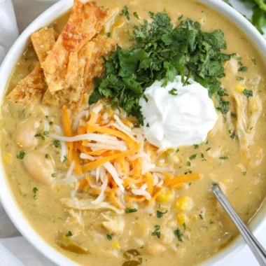 Bowl of easy green enchilada chicken soup with toppings and green chilies
