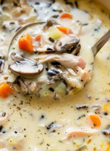 Bowl of homemade leftover turkey wild rice soup garnished with herbs