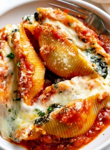 Delicious stuffed shells filled with ricotta cheese and herbs topped with marinara sauce